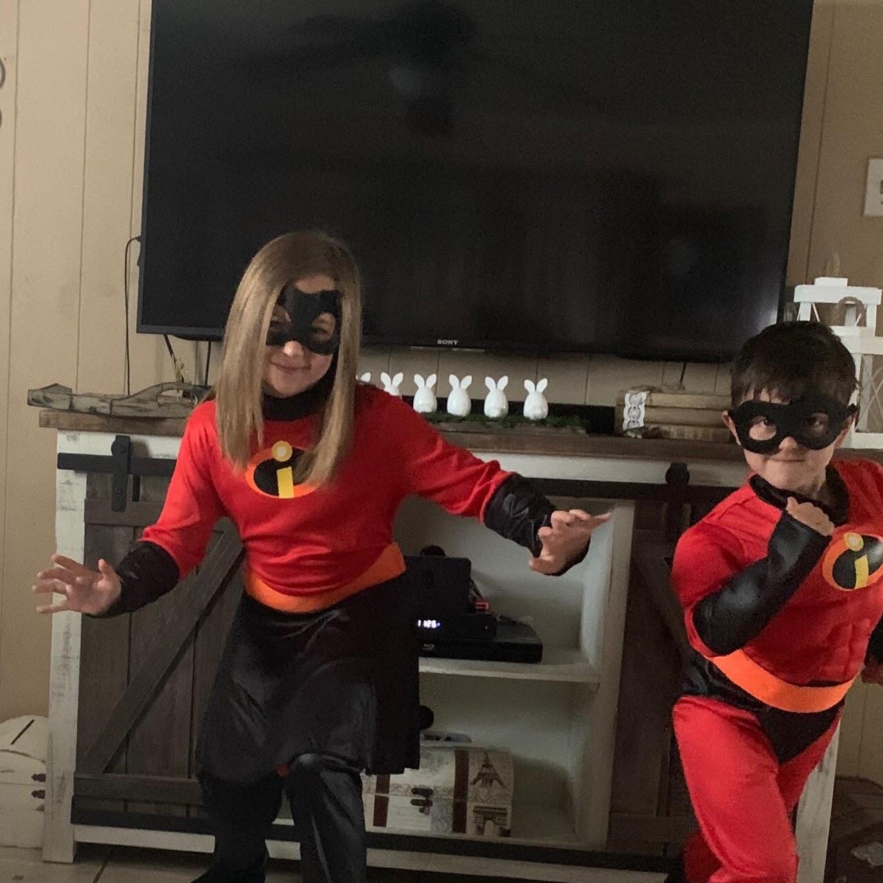 Two children dressed as superheroes